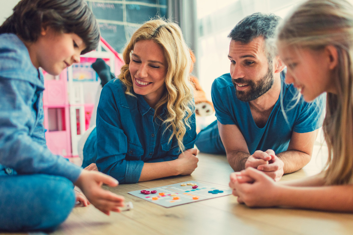 Family Playing Board Game At Home