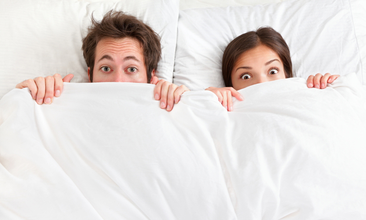 couple hiding under the covers