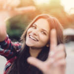 smiling woman making a frame with hands