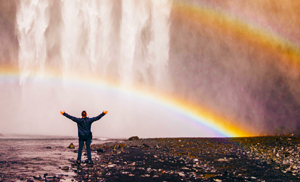 man rainbow waterfall