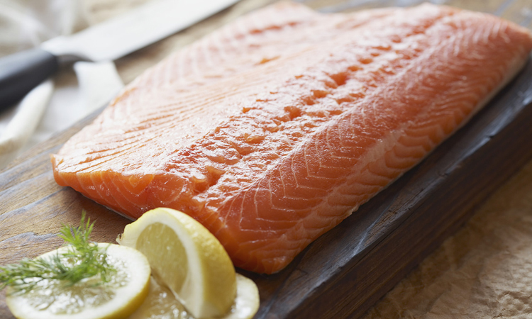 Slice of salmon with lemons --- Image by © Kate Kunz/Corbis