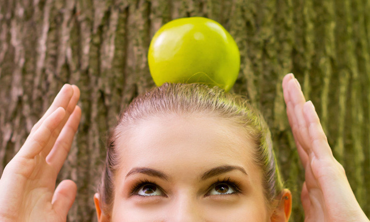 woman balancing an apple on top her head