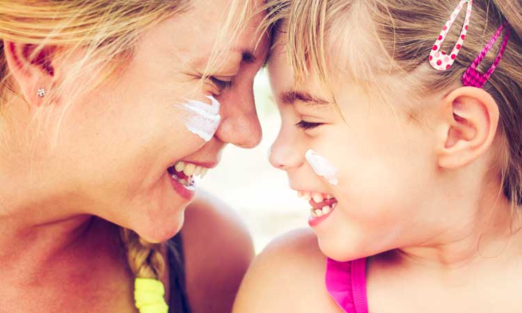 How-To-Make-Homemade-Sunscreen mother and child with sunscreen on their face