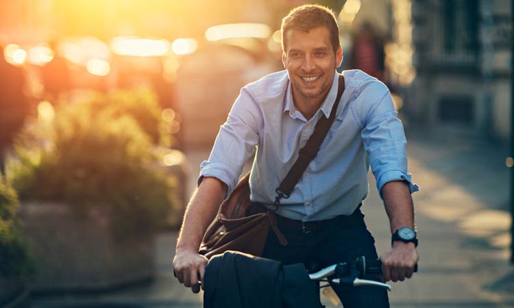 Biking-To-Work-Lowers-Mortality businessman bicycling to work
