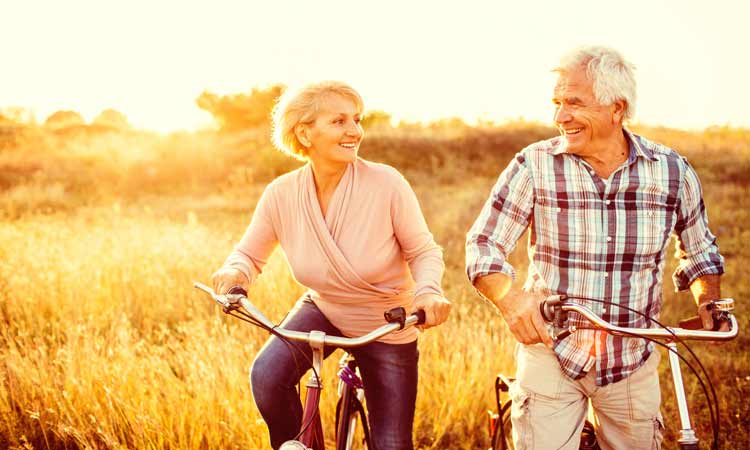 Courageous-Aging senior couple on bicycle