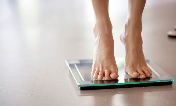 woman on scale for weight loss