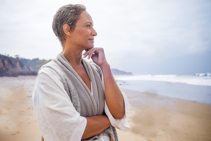 Woman looking over ocean with energy