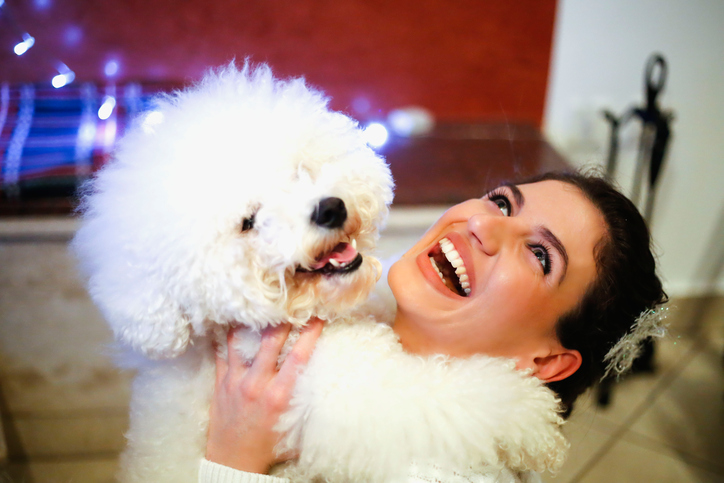 Happy woman laughing with her dog