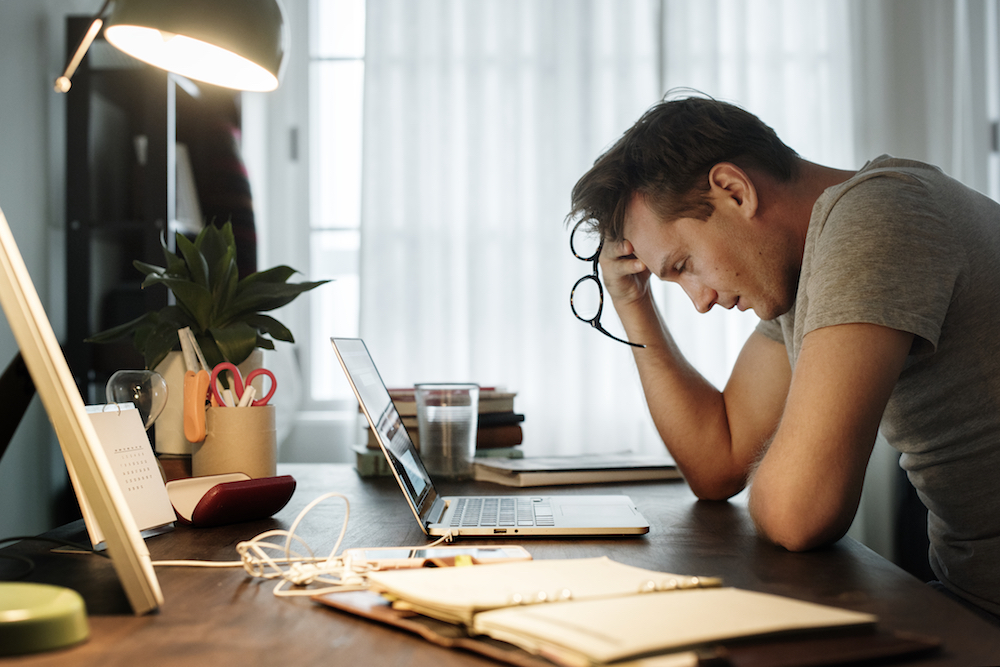 stress: Man stressed while working on laptop