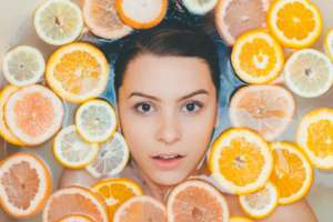 woman bathing in citrus fruits fighting skin pollution with natural skin care