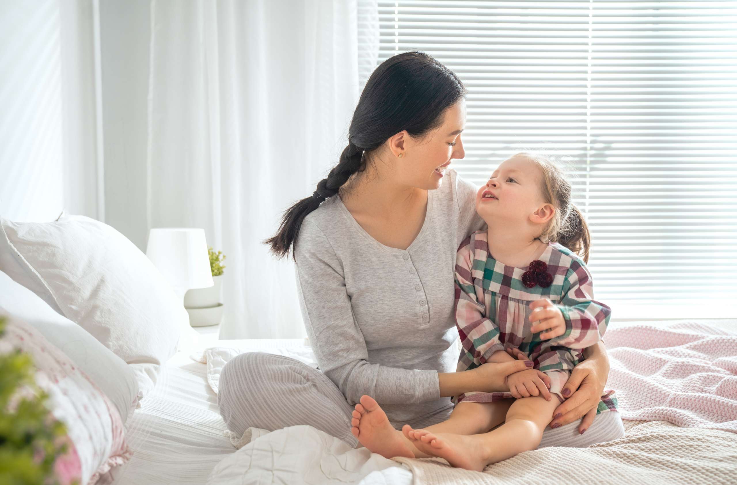 baby girl and her mother playing